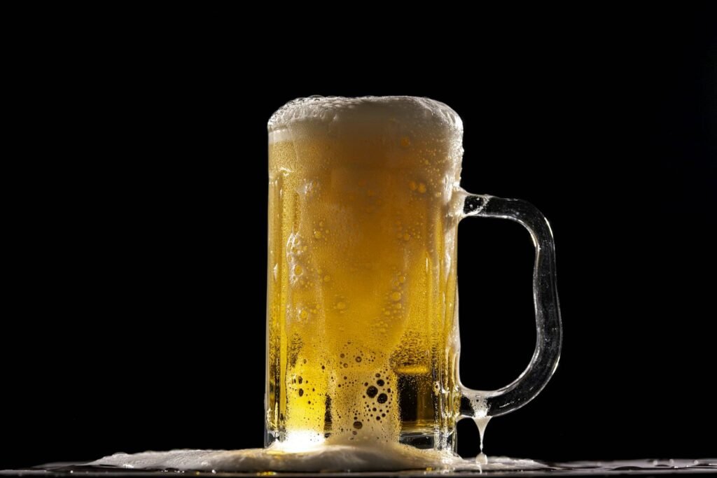 A frosted mug of lager with foam running down the side